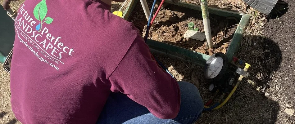 Employee checking irrigation water pressure in Memphis, TN.