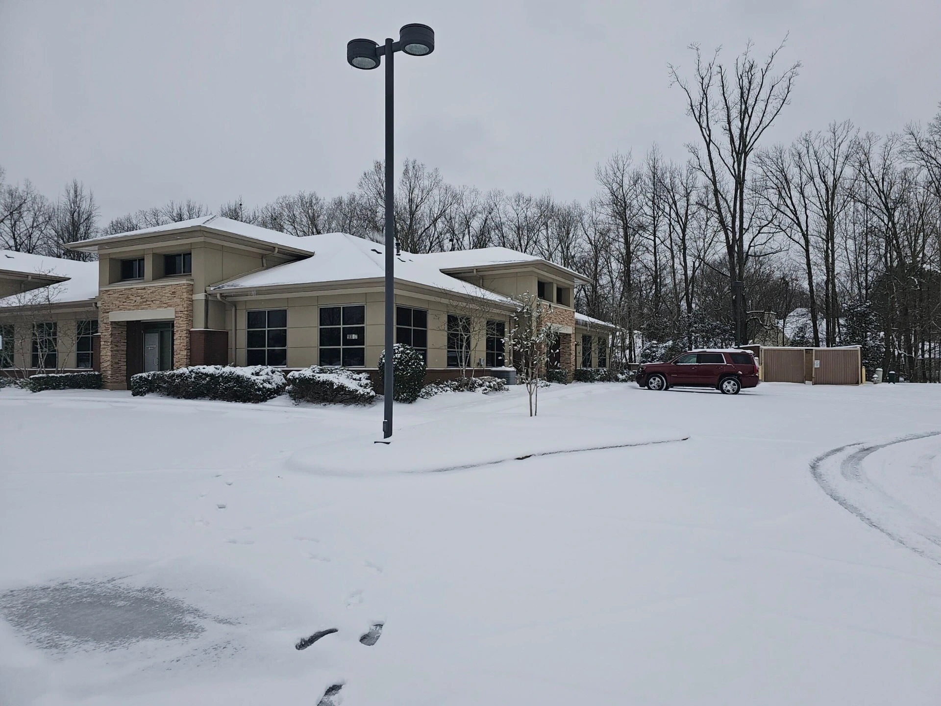 Snow-covered parking lot at business in Memphis, TN.